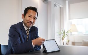 Men showing stock charts smiling